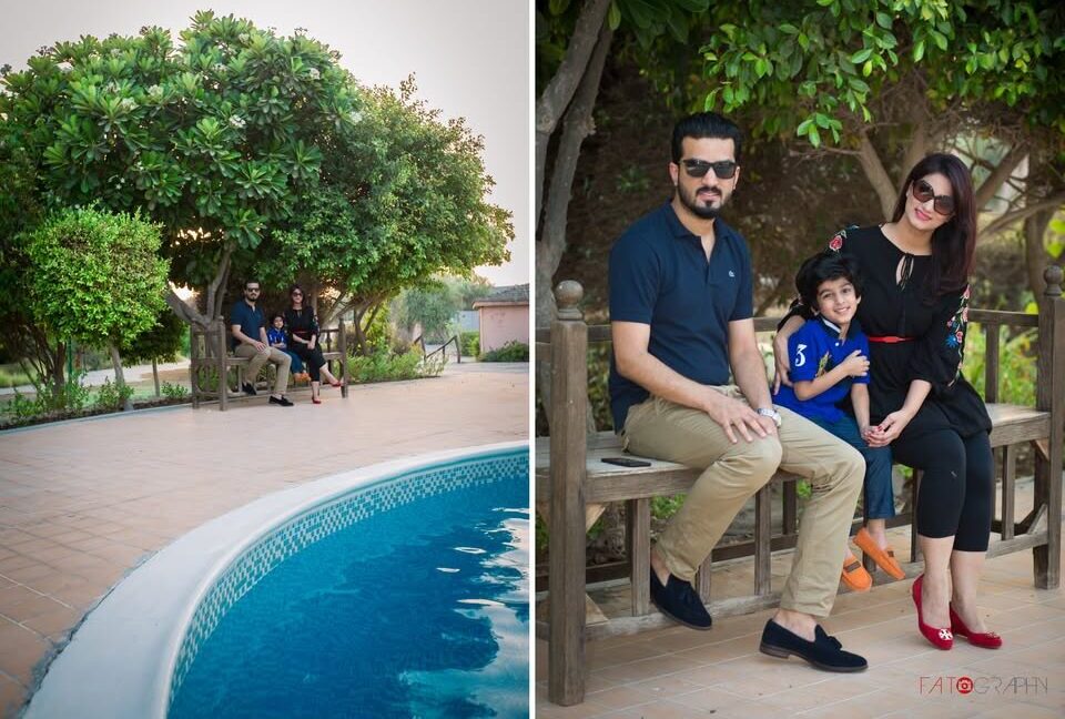 Parents enjoying candid family moments with their child during a Fatography photoshoot in Dubai park.