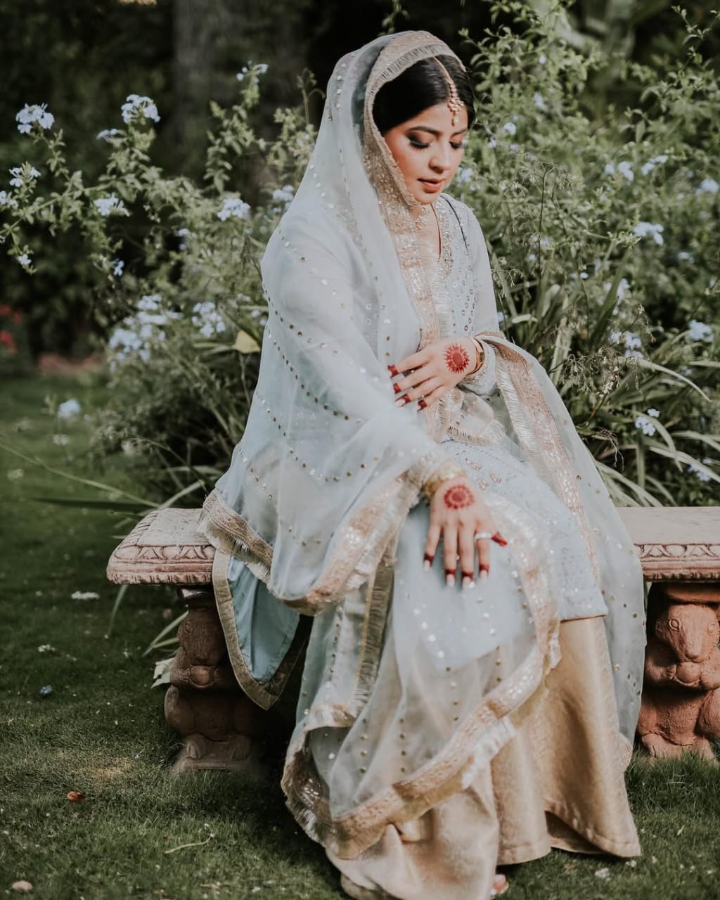 Couple lying on garden grass looking at each other during pre-wedding shoot