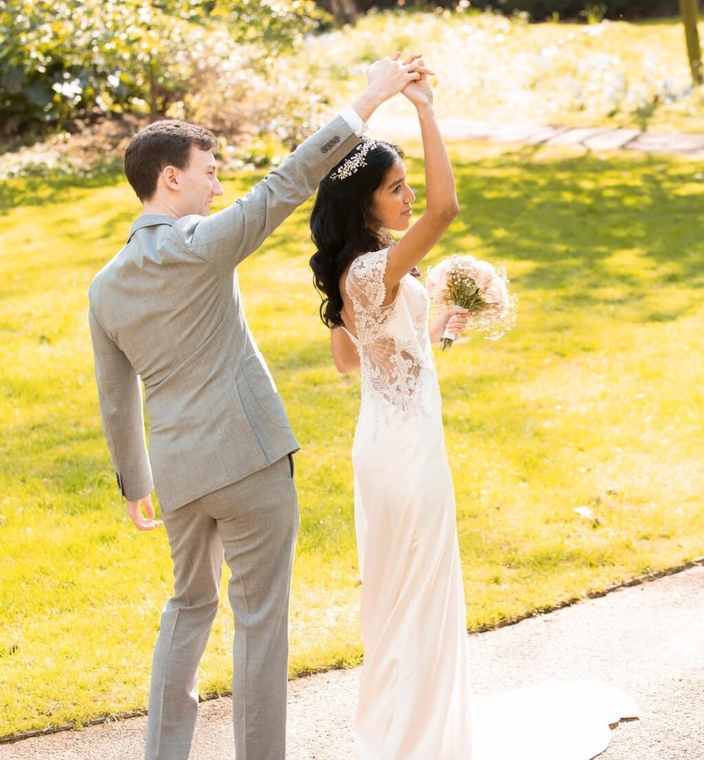 Groom in black suit sitting on a bench along the street during a Fatography pre wedding photoshoot.