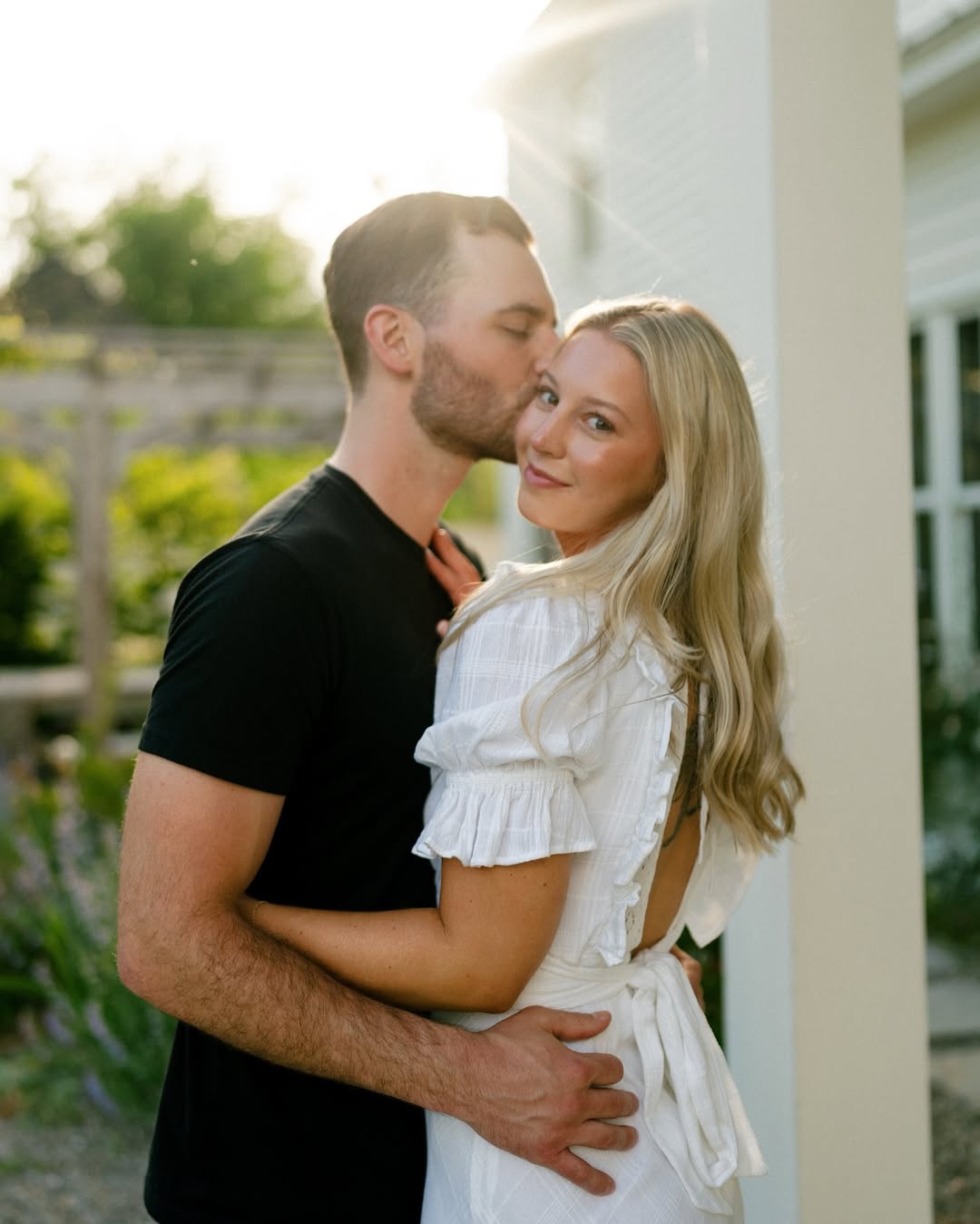 Couple posing in a lush green garden during a Fatography pre wedding shoot.