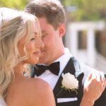 The groom gently kissing the bride's cheek in a loving, candid moment during their wedding day portraits.