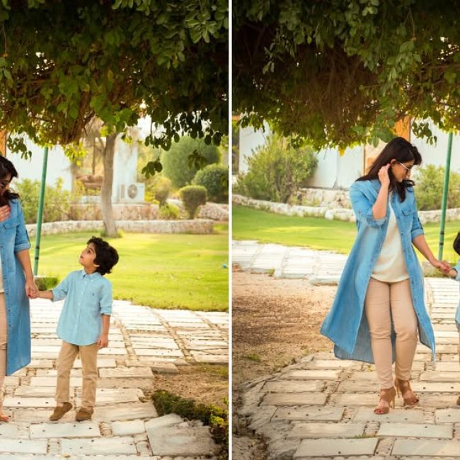 Parents hugging their daughter in garden area