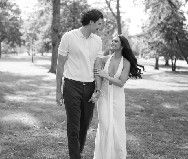 Couple touching noses with buildings in the background during a Fatography pre wedding photoshoot.