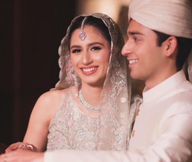 Indoor pre-wedding shoot under grand chandelier in wedding hall
