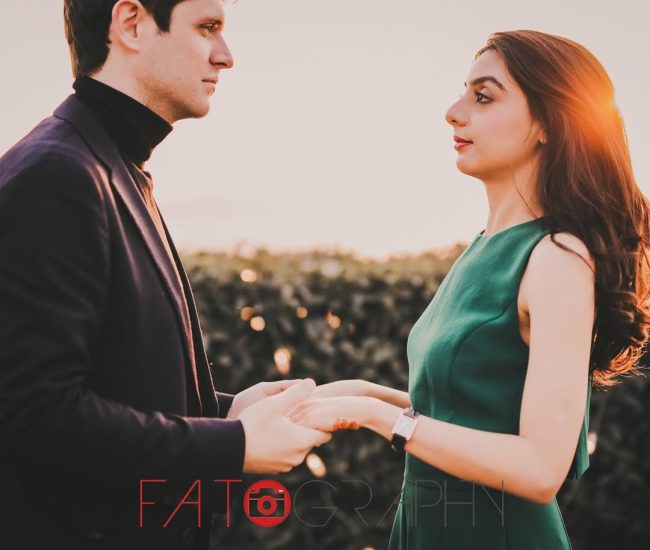 A close-up shot of the couple's faces, with a blurry, soft-focus background, creating an intimate and romantic feel.