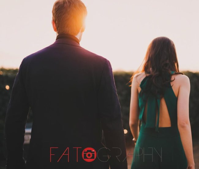 * Alt Text: The bride and groom standing with their backs to the camera, looking out at a scenic view during their pre-wedding photoshoot.