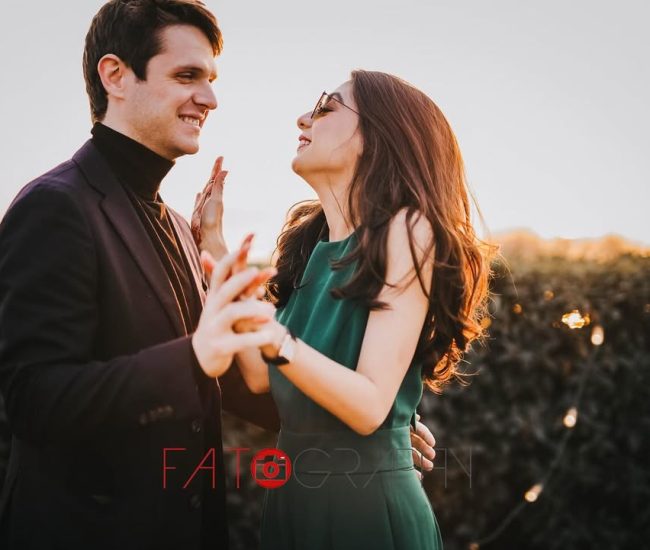 The couple standing together and sharing a warm, loving glance during their candid pre-wedding photo session.
