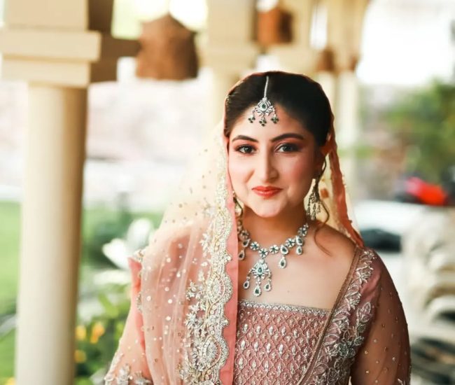 Pre-wedding photoshoot with couple holding hands near flower bed
