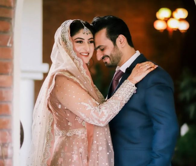 Couple reading book together during pre-wedding shoot in garden
