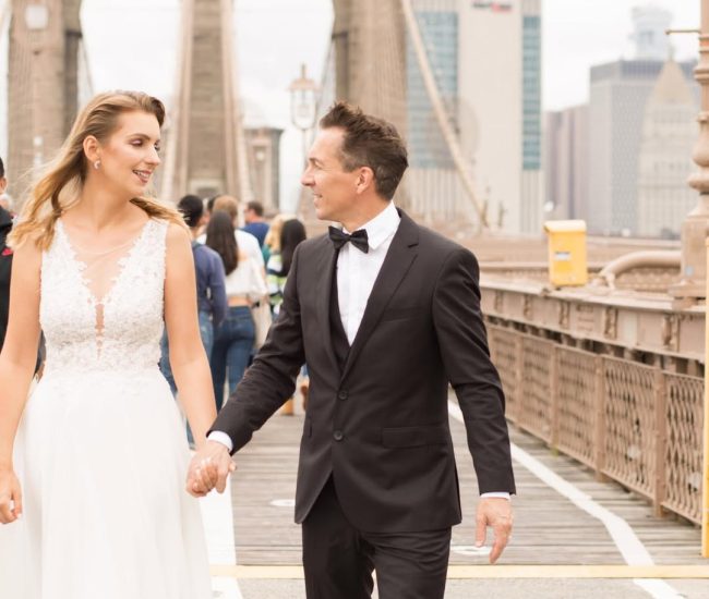 Groom in formal suit posing confidently on bridge during Fatography pre wedding shoot.