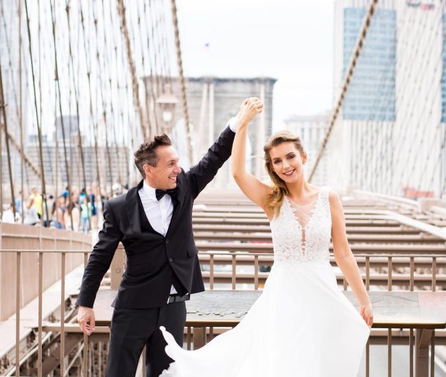 Groom sitting stylishly near a bridge in the city during Fatography pre wedding photoshoot.