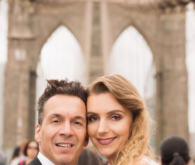 Groom resting hand on bridge handrail during Fatography pre wedding photoshoot.