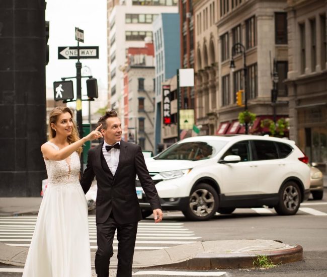 Groom walking across a crosswalk near the bridge during Fatography pre wedding shoot.