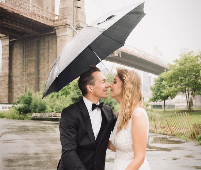 Groom posing at a city bridge during evening lights in a Fatography pre wedding session.