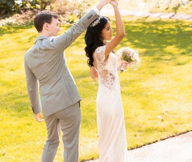 Groom in black suit sitting on a bench along the street during a Fatography pre wedding photoshoot.
