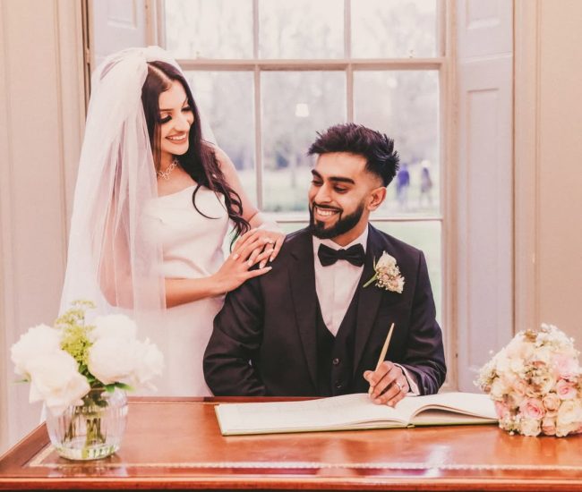 Pre-wedding couple sitting together at decorated table indoors