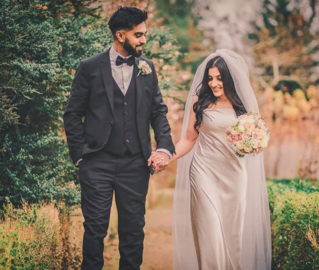 Bride standing with bouquet in outdoor garden pre-wedding shoot