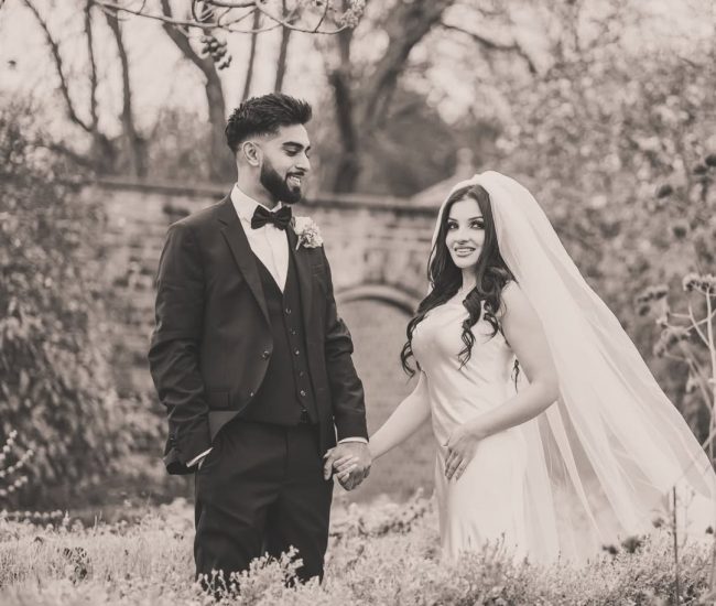 Pre-wedding couple embracing in outdoor garden photoshoot