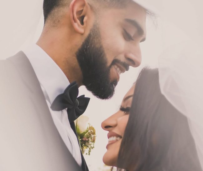 Couple smiling close-up portrait in garden pre-wedding shoot