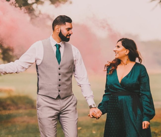 A long shot of the large garden fountain surrounded by manicured trees, highlighting the tranquil outdoor setting.