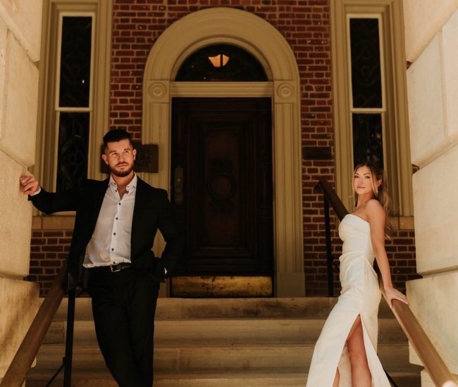 Couple walking casually in front of urban buildings during a Fatography pre wedding photoshoot.