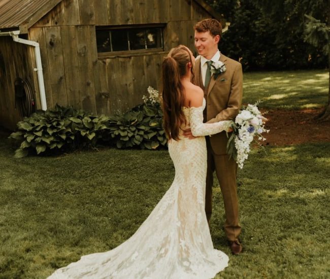 Couple standing under a floral garden arch captured by Fatography pre wedding photography.