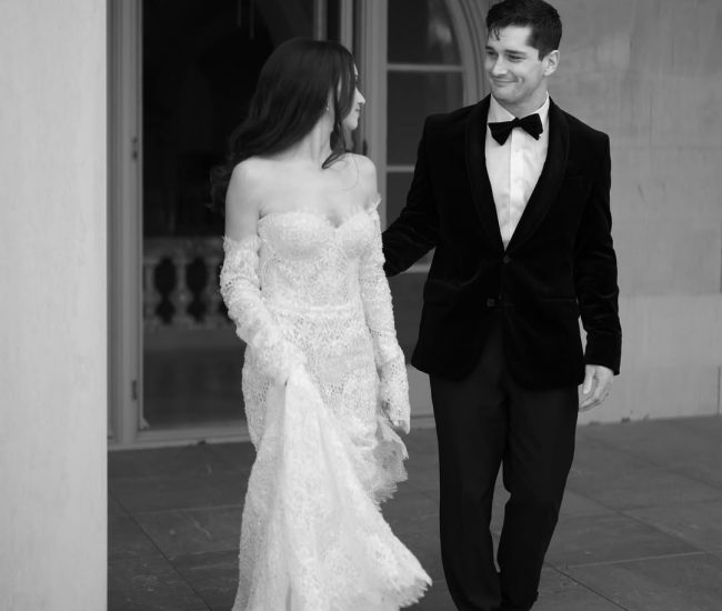 Bride in white and groom in black outfits posing for a Fatography pre wedding indoor shoot.