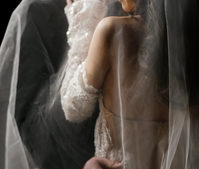 Close-up indoor couple portrait, bride in white suit and groom in black suit, by Fatography pre wedding photography.