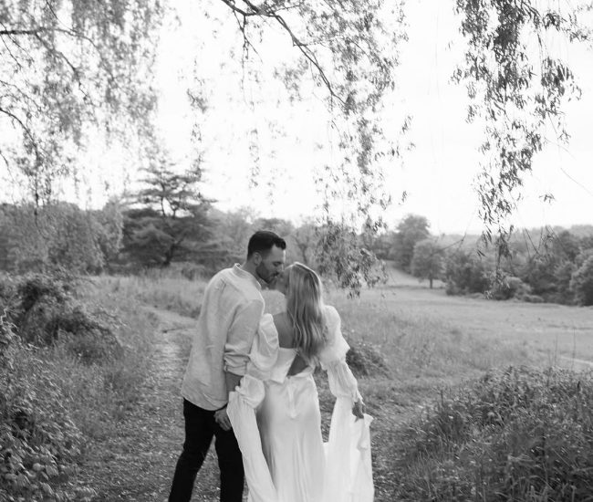 Bride and groom walking hand in hand in greenery during a Fatography pre wedding shoot.
