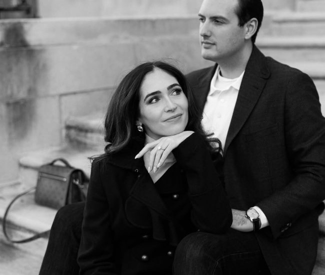 Couple posing under an umbrella in the rain during a Fatography pre wedding shoot