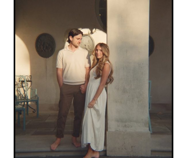 Couple standing on balcony during a Fatography pre wedding photoshoot.