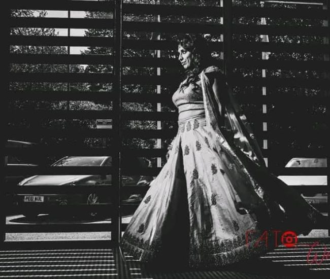 Bride in flowing gown descending stairs at wedding venue — best wedding events Dubai, wedding events Dubai guide