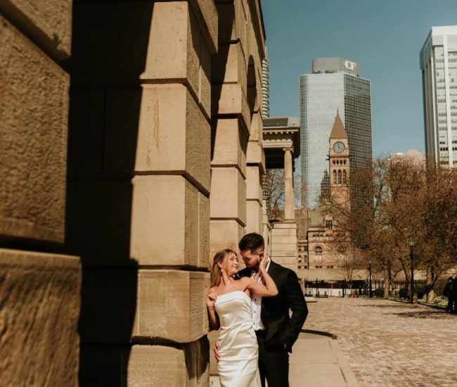 Couple walking together on a city street during a Fatography pre wedding photoshoot.