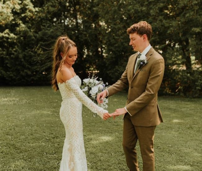 Couple sitting together on a wooden bench in a garden during a Fatography pre wedding shoot.